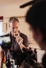 Load image into Gallery viewer, Evans &amp; Tate winemaker smelling Wild Cape Sauvignon Blanc wine during photo shoot
