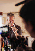 Load image into Gallery viewer, Evans & Tate winemaker smelling Wild Cape Sauvignon Blanc wine during photo shoot
