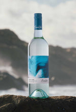 Load image into Gallery viewer, Bottle of Wild Cape Sauvignon Blanc wine on a rock at the ocean