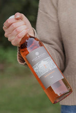 Load image into Gallery viewer, Cellar door manager holding a bottle of Deep Woods Harmony Rose wine
