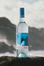 Load image into Gallery viewer, Bottle of Wild Cape Sauvignon Blanc wine on a rock at the ocean
