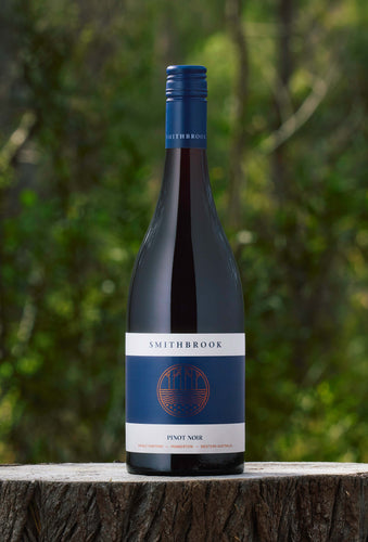 Bottle of Smithbrook Single Vineyard Pinot Noir wine in Pemberton forest